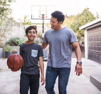 father and son with basketball