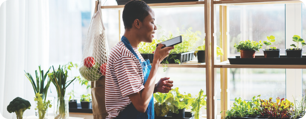 A woman on the phone with plants