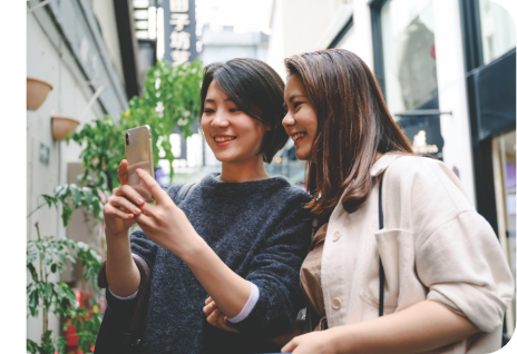 Two women looking at a mobile phone