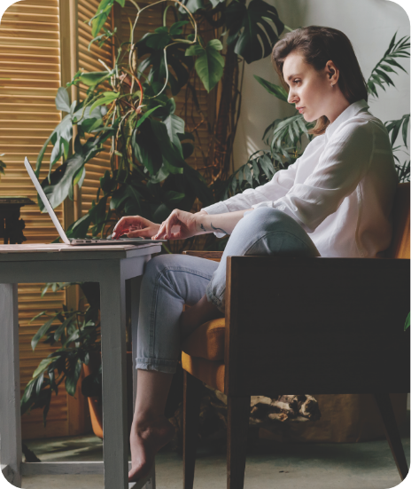 A woman at a desk working on a laptop