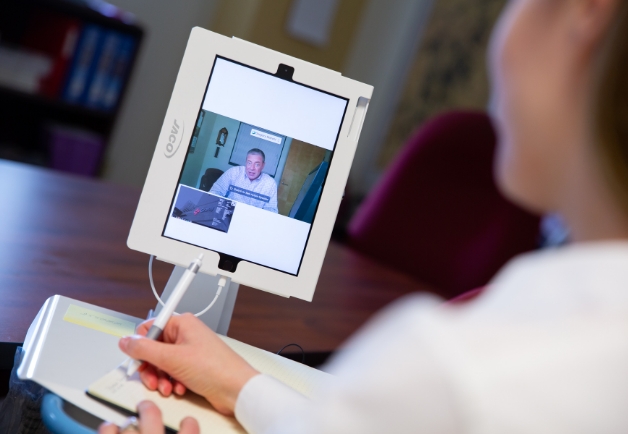 Doctor talking with a patient through a tablet
