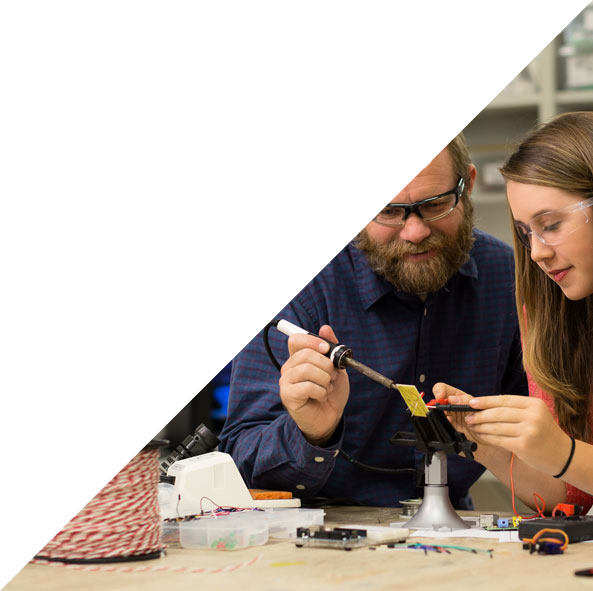 Teacher and student working on electronics