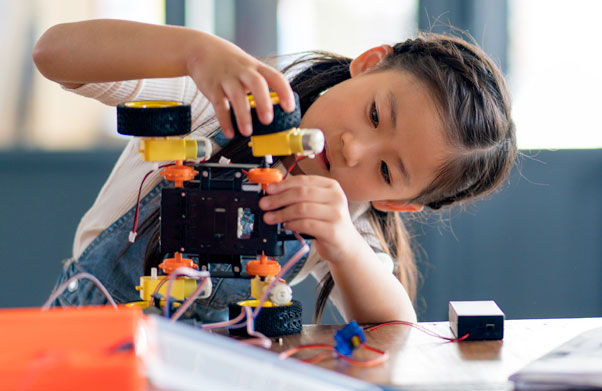 girl putting together car