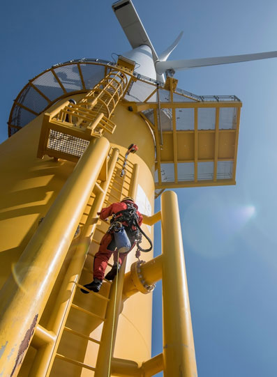 man climbing windmill