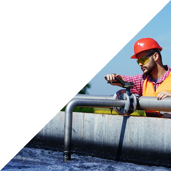 Man with tool fixing pipe at water tank