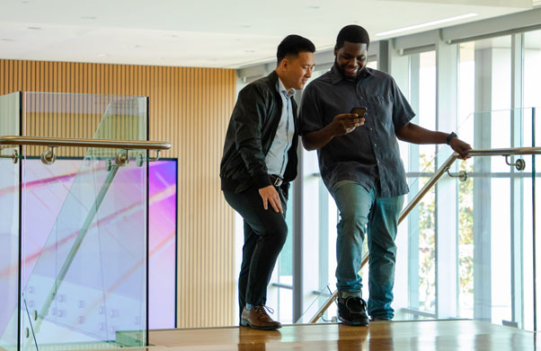 Two people looking at a phone