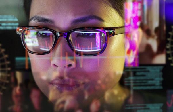 Woman looking at screen through glasses