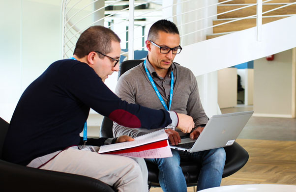 Two men looking at laptop