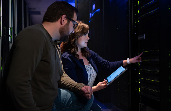 Two people in a server room