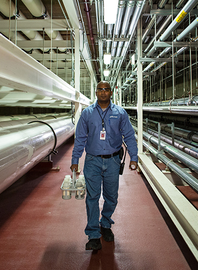 man walking next to pipe lines