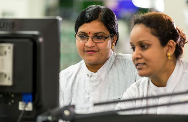 Two women looking at computer screen