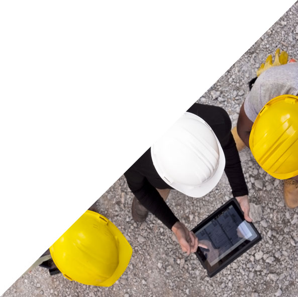 Three construction workers looking at tablet