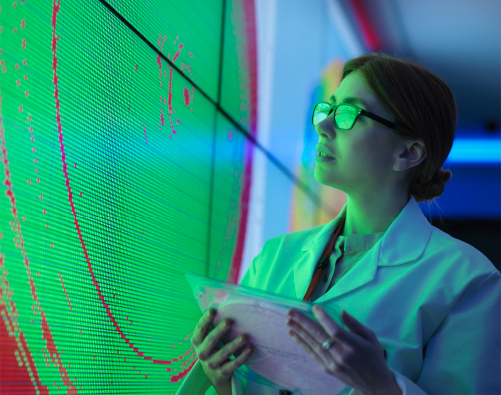 Woman with clip board looking at a screen