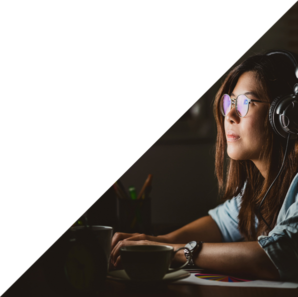 Woman with headphones on looking at screen